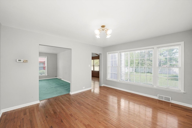 255 Irving Blvd, Chicago Heights, IL 60411 - empty room featuring a chandelier, baseboards, and wood finished floors