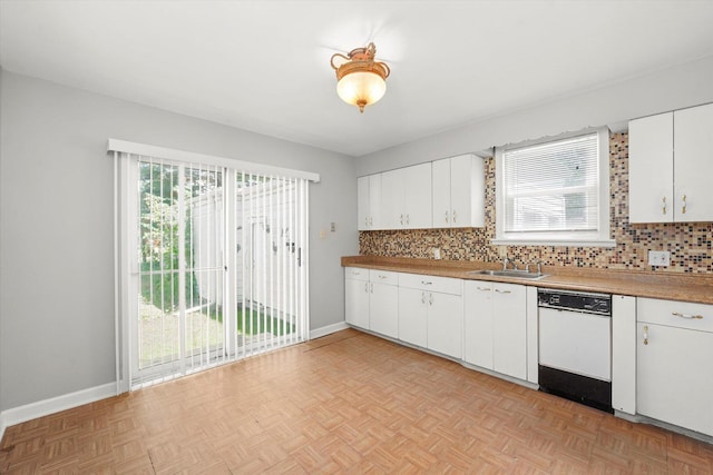 255 Irving Blvd, Chicago Heights, IL 60411 - kitchen featuring white dishwasher, a sink, tasteful backsplash, and white cabinets