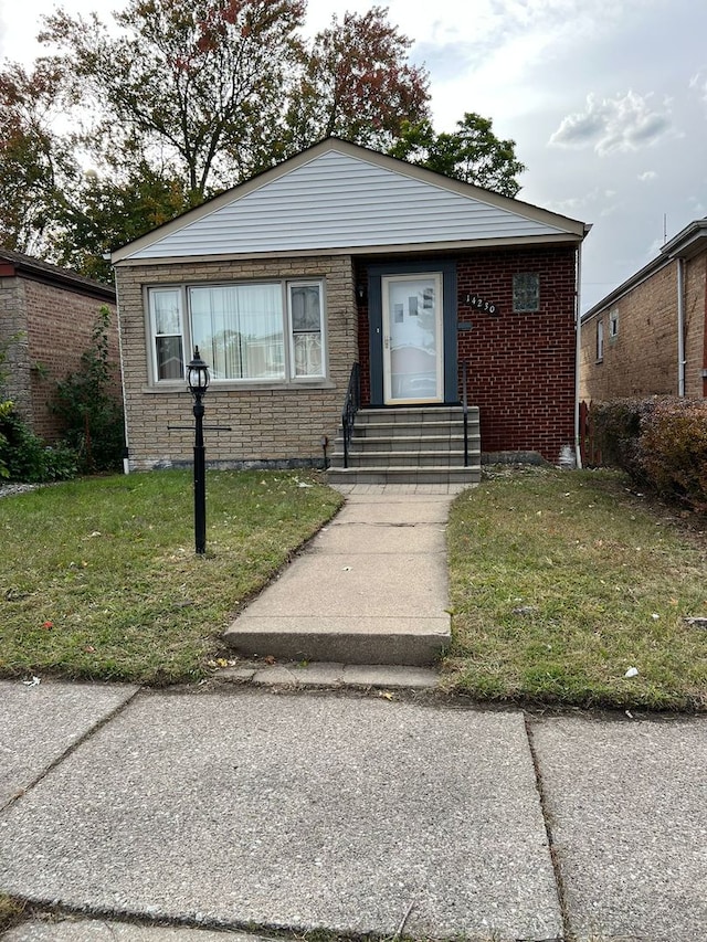 14230 S State St, Riverdale, IL 60827 - bungalow with brick siding, a front lawn, and entry steps