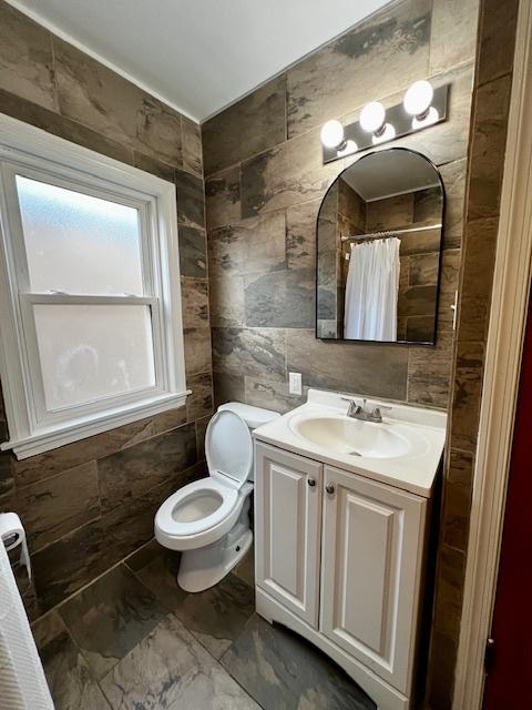 14230 S State St, Riverdale, IL 60827 - full bathroom with marble finish flooring, tile walls, toilet, vanity, and a shower with curtain
