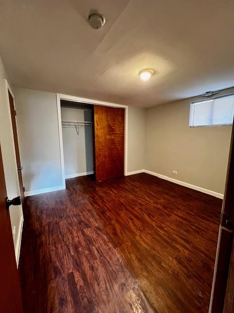 14230 S State St, Riverdale, IL 60827 - unfurnished bedroom with baseboards, wood finished floors, and a closet