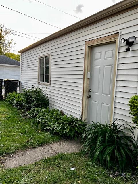 14230 S State St, Riverdale, IL 60827 - doorway to property with fence and central air condition unit