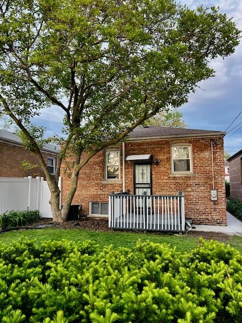 14230 S State St, Riverdale, IL 60827 - view of front of property featuring fence, brick siding, and central air condition unit