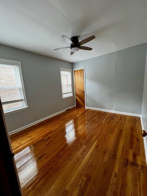 14230 S State St, Riverdale, IL 60827 - empty room featuring ceiling fan, baseboards, and wood finished floors
