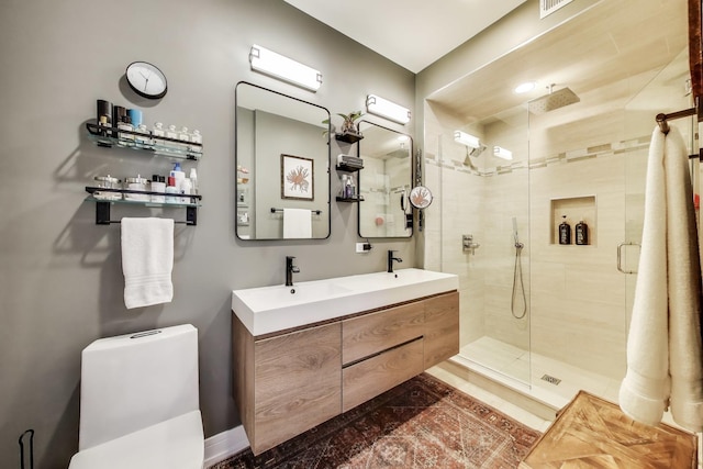 full bath featuring a shower stall, toilet, and double vanity