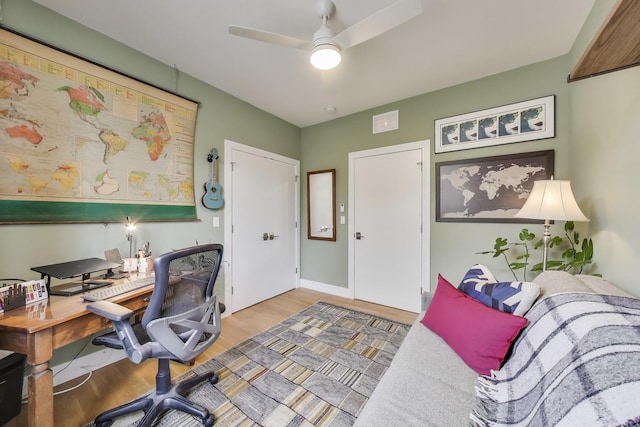 office area with wood finished floors and a ceiling fan