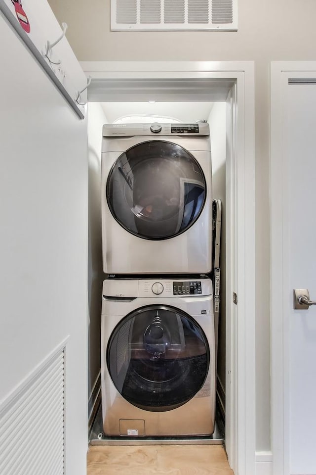 laundry room featuring stacked washer / dryer
