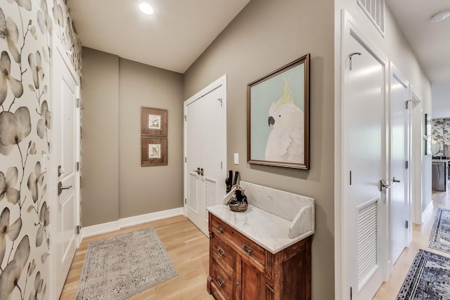 bathroom with wood finished floors and baseboards