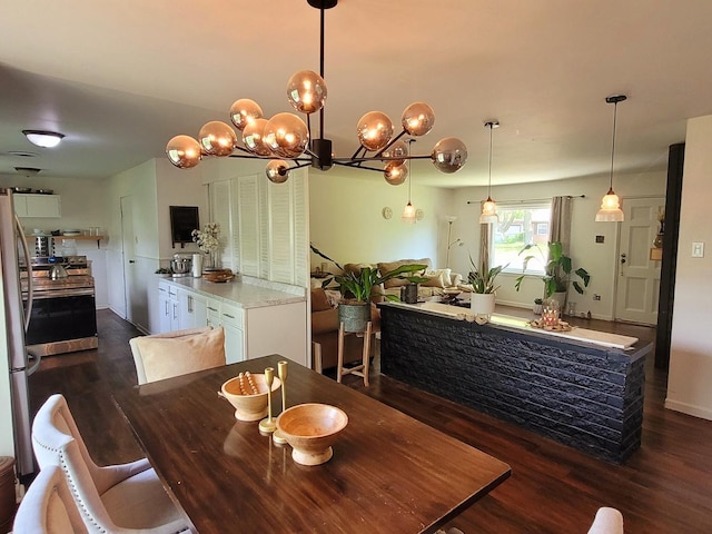 dining space with dark wood-style floors and a chandelier