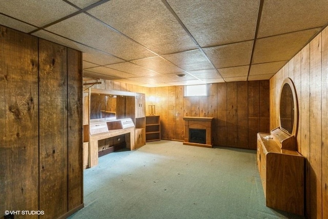11616 Ronald St, Huntley, IL 60142 - basement with wooden walls, a drop ceiling, carpet, and a fireplace