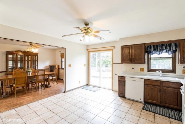 11616 Ronald St, Huntley, IL 60142 - kitchen featuring white dishwasher, a sink, ceiling fan, light countertops, and healthy amount of natural light
