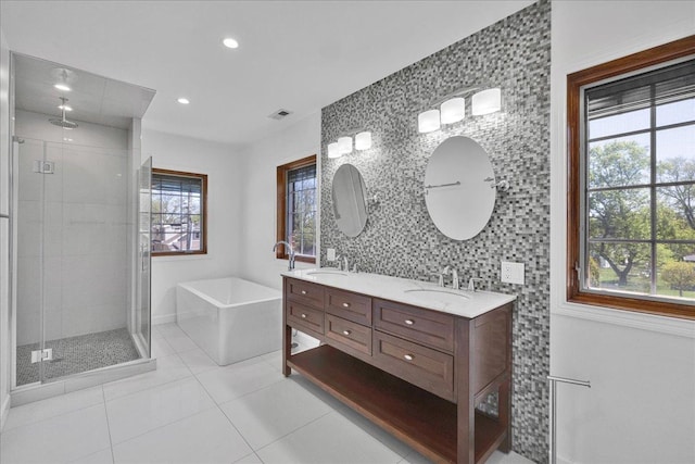 7439 W Lunt Ave, Chicago, IL 60631 - full bath with a stall shower, healthy amount of natural light, tile patterned floors, a soaking tub, and recessed lighting