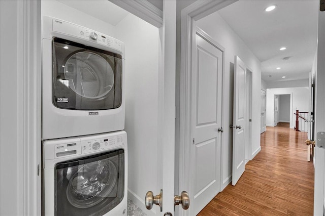 7439 W Lunt Ave, Chicago, IL 60631 - laundry room featuring estacked washer and dryer, wood finished floors, baseboards, and recessed lighting