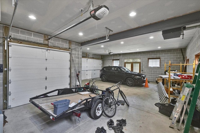 7439 W Lunt Ave, Chicago, IL 60631 - garage featuring a garage door opener, concrete block wall, and recessed lighting