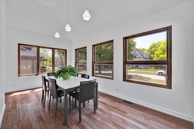 7439 W Lunt Ave, Chicago, IL 60631 - dining area featuring baseboards, lofted ceiling, and dark wood-type flooring
