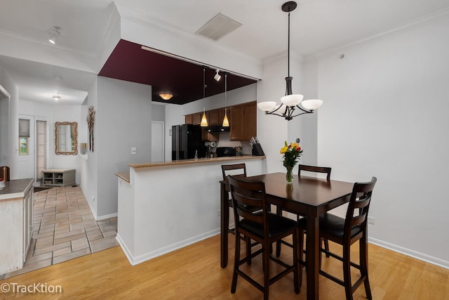 1102 E Cambria Ln, Lombard, IL 60148 - dining space featuring a chandelier, baseboards, and crown molding