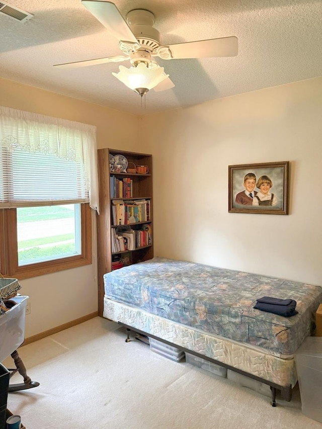 1004 N Hill Dr, Dixon, IL 61021 - bedroom with carpet flooring, a textured ceiling, and a ceiling fan