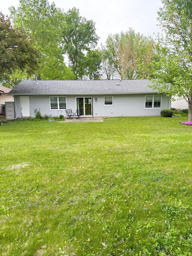 1004 N Hill Dr, Dixon, IL 61021 - back of house with a patio area and a lawn