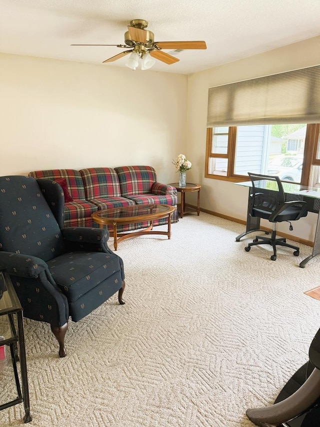 1004 N Hill Dr, Dixon, IL 61021 - carpeted living area featuring baseboards, ceiling fan, and a desk
