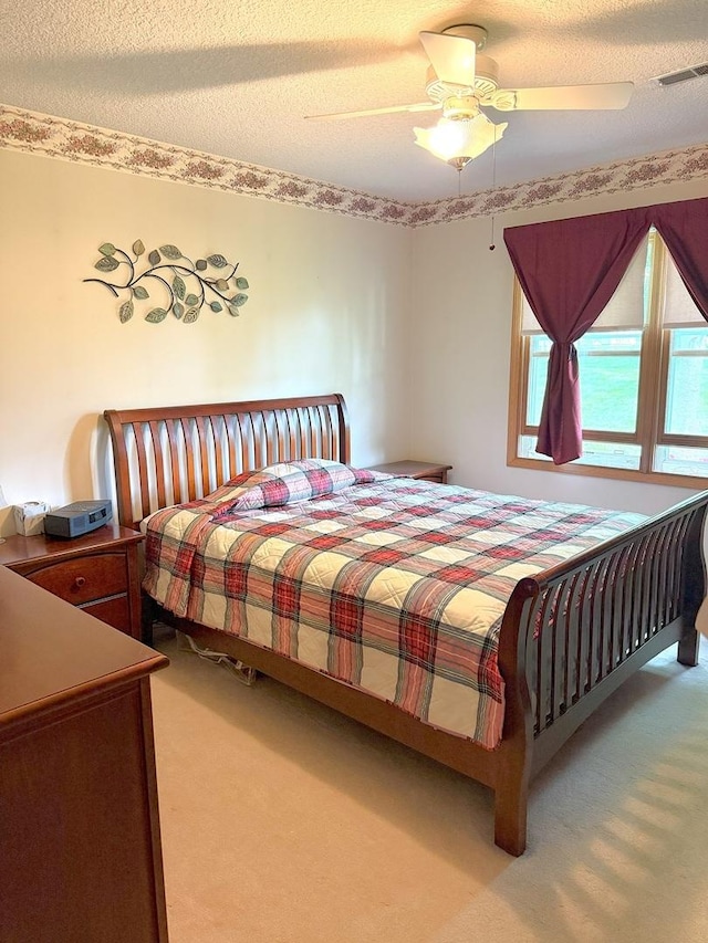 1004 N Hill Dr, Dixon, IL 61021 - bedroom featuring carpet floors, a ceiling fan, and a textured ceiling