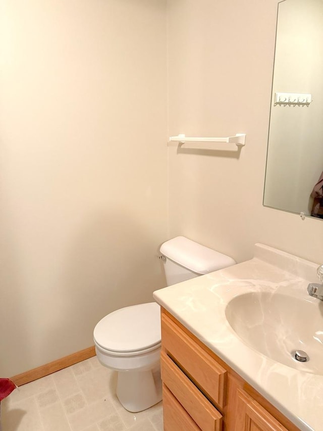1004 N Hill Dr, Dixon, IL 61021 - bathroom featuring toilet, vanity, and baseboards