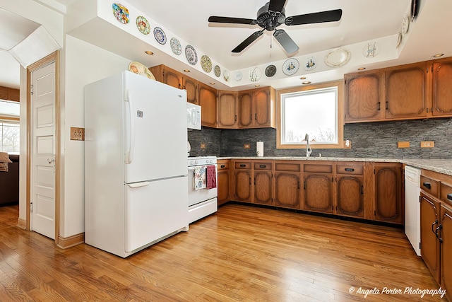 41551 N Lotus Ave, Antioch, IL 60002 - kitchen featuring white appliances, brown cabinetry, a ceiling fan, light wood-type flooring, and tasteful backsplash