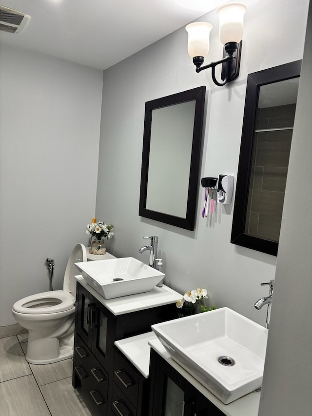 bathroom with toilet and vanity