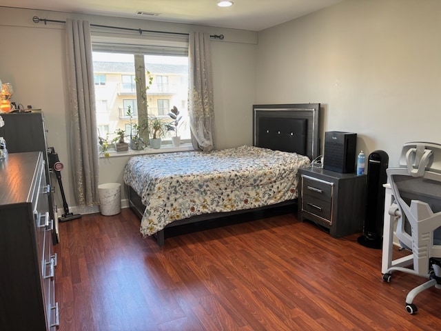 bedroom with dark wood finished floors and recessed lighting