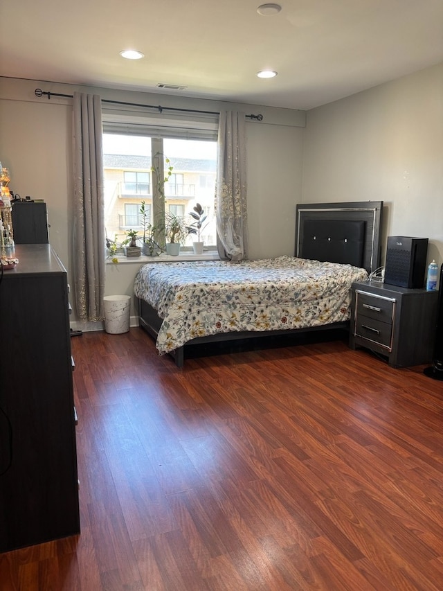bedroom with dark wood-type flooring and recessed lighting