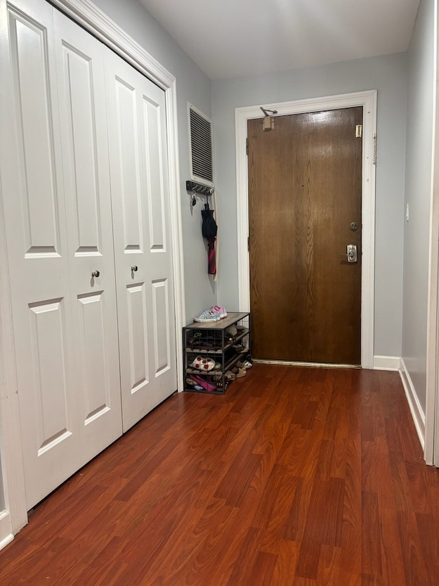 doorway to outside featuring wood finished floors and baseboards