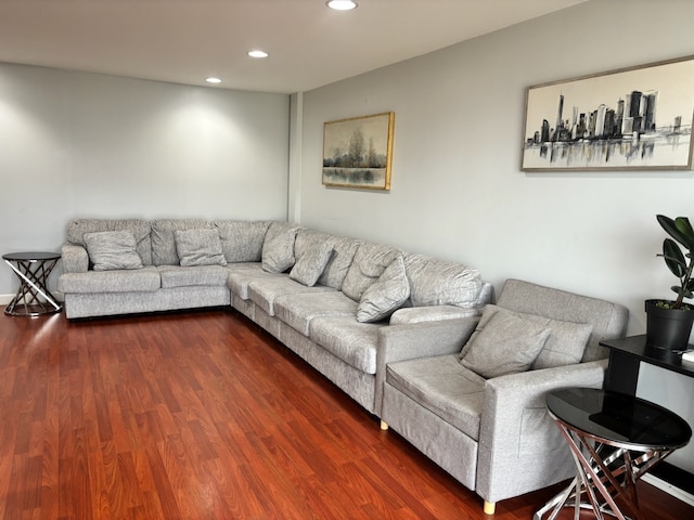 living room with recessed lighting and dark wood-type flooring