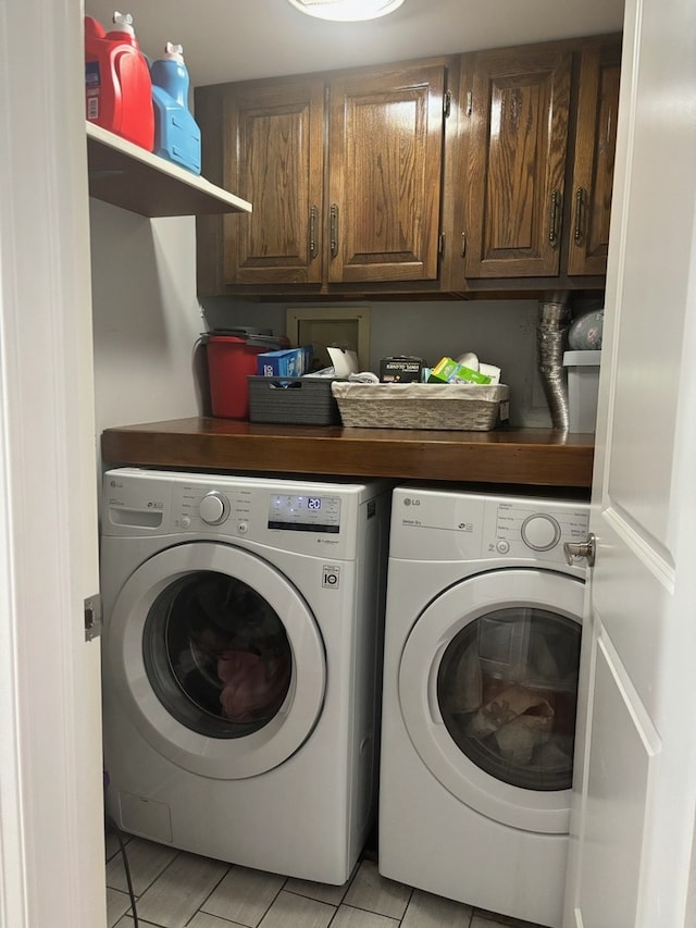 laundry area with washer and dryer and cabinet space