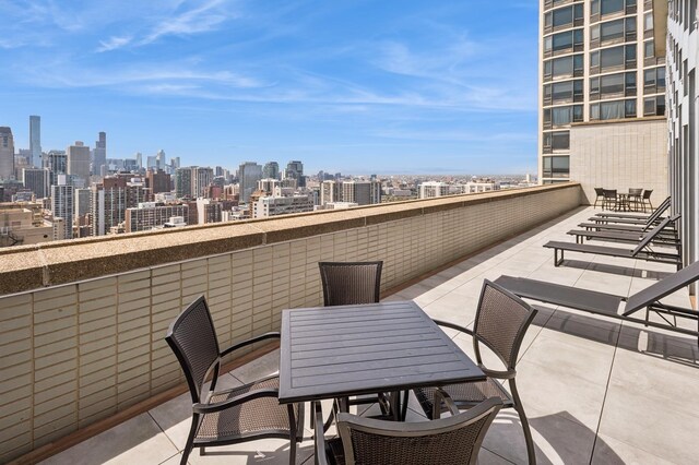 view of patio featuring a view of skyline and outdoor dining space