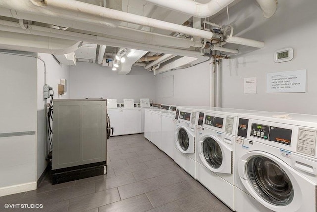 communal laundry room with washer and clothes dryer and tile patterned floors