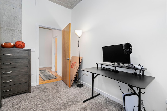 home office featuring carpet and baseboards