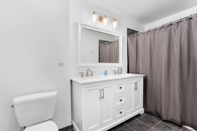 full bathroom with toilet, double vanity, and tile patterned floors
