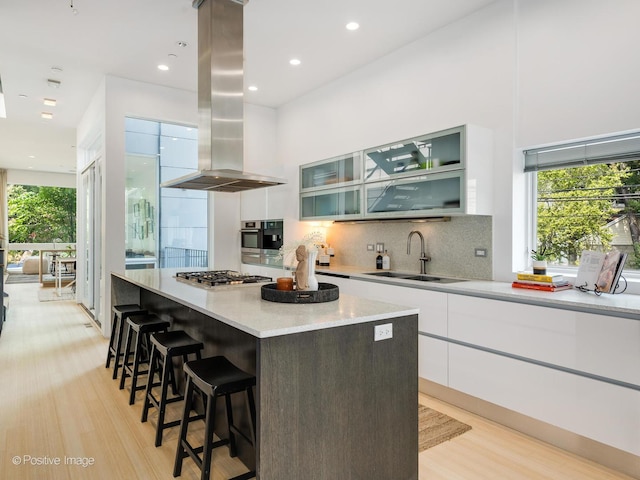 1729 W Potomac Ave, Chicago, IL 60622 - kitchen featuring island range hood, light wood-style flooring, modern cabinets, a kitchen island, and recessed lighting