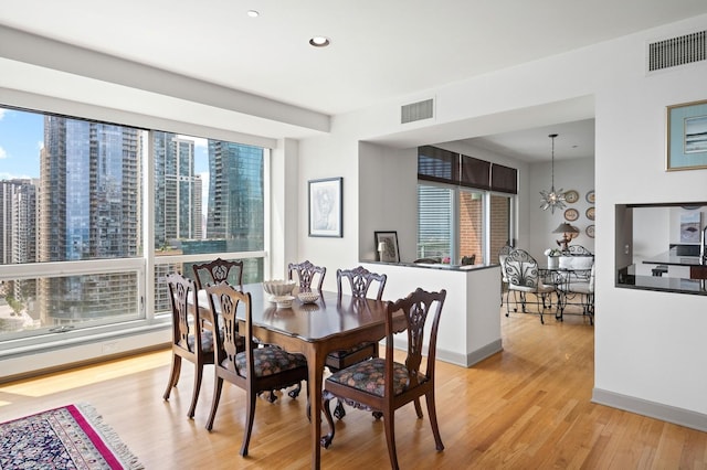 445 E N Water St Unit 2105, Chicago, IL 60610 - dining area with light wood finished floors, a chandelier, and recessed lighting