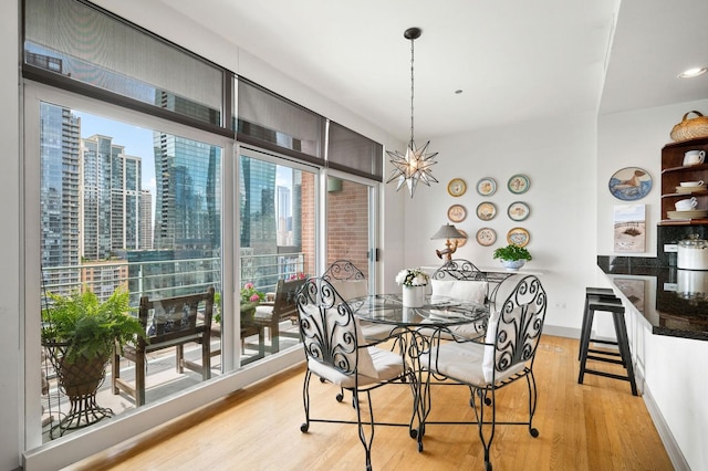 445 E N Water St Unit 2105, Chicago, IL 60610 - dining room with light wood-style flooring, a view of city, and a chandelier
