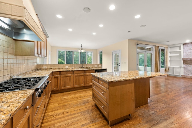 1161 Gavin Ct, Lake Forest, IL 60045 - kitchen featuring a sink, stainless steel gas cooktop, premium range hood, light wood-style floors, and brown cabinetry