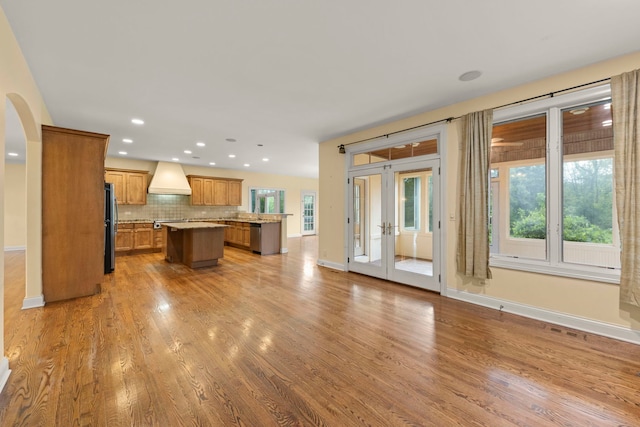 1161 Gavin Ct, Lake Forest, IL 60045 - kitchen featuring stainless steel appliances, premium range hood, a center island, brown cabinets, and wood finished floors