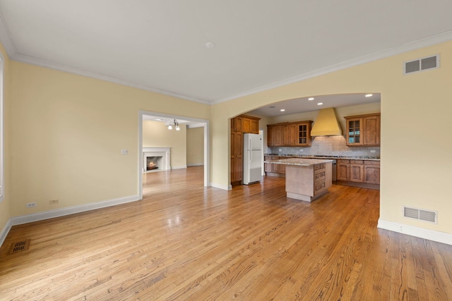 1161 Gavin Ct, Lake Forest, IL 60045 - kitchen with custom exhaust hood, freestanding refrigerator, brown cabinets, open floor plan, and a kitchen island