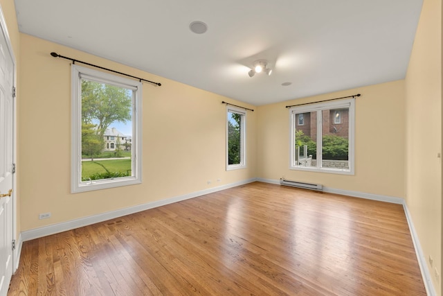 1161 Gavin Ct, Lake Forest, IL 60045 - unfurnished room featuring a baseboard radiator, healthy amount of natural light, wood finished floors, and baseboards