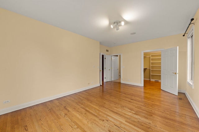 1161 Gavin Ct, Lake Forest, IL 60045 - unfurnished bedroom featuring a walk in closet, baseboards, light wood-type flooring, and a closet
