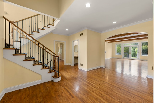 1161 Gavin Ct, Lake Forest, IL 60045 - entrance foyer featuring arched walkways, crown molding, wood finished floors, baseboards, and stairway