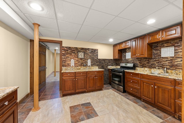 1161 Gavin Ct, Lake Forest, IL 60045 - kitchen featuring stainless steel gas range oven, a sink, light stone counters, backsplash, and brown cabinetry