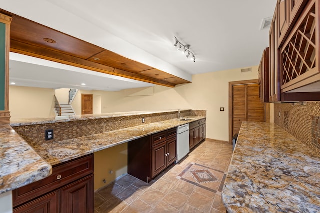 1161 Gavin Ct, Lake Forest, IL 60045 - kitchen featuring white dishwasher, light stone countertops, a sink, rail lighting, and backsplash