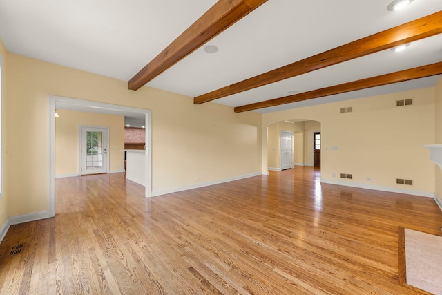 1161 Gavin Ct, Lake Forest, IL 60045 - unfurnished living room with arched walkways, light wood-style floors, beam ceiling, and baseboards