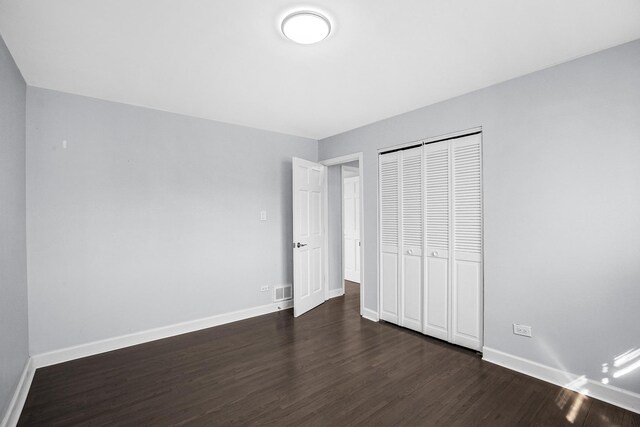16779 92nd Ave, Orland Hills, IL 60487 - unfurnished bedroom with dark wood-type flooring, baseboards, and a closet