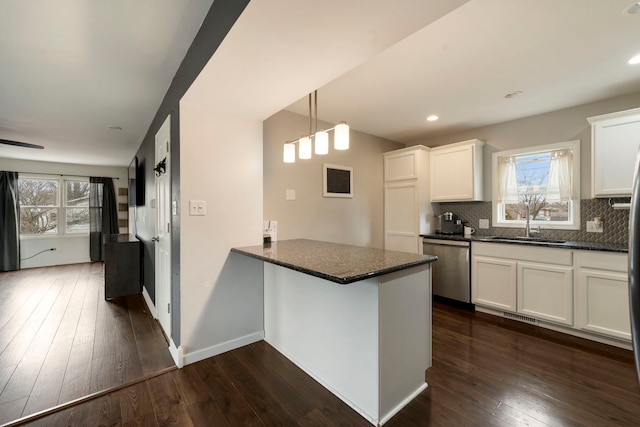 16040 Lockwood Ave, Oak Forest, IL 60452 - kitchen with stainless steel dishwasher, a peninsula, a sink, white cabinets, and tasteful backsplash